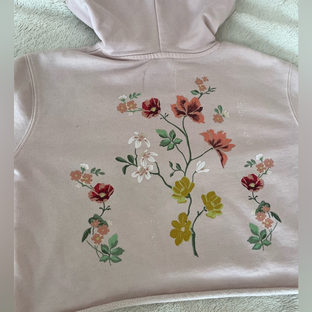 Cropped pink hoodie with floral design on back
